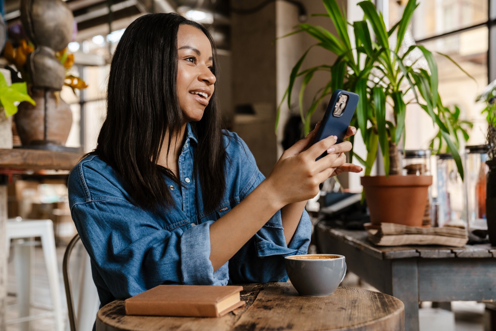 A woman viewing her social media feed on her phone.