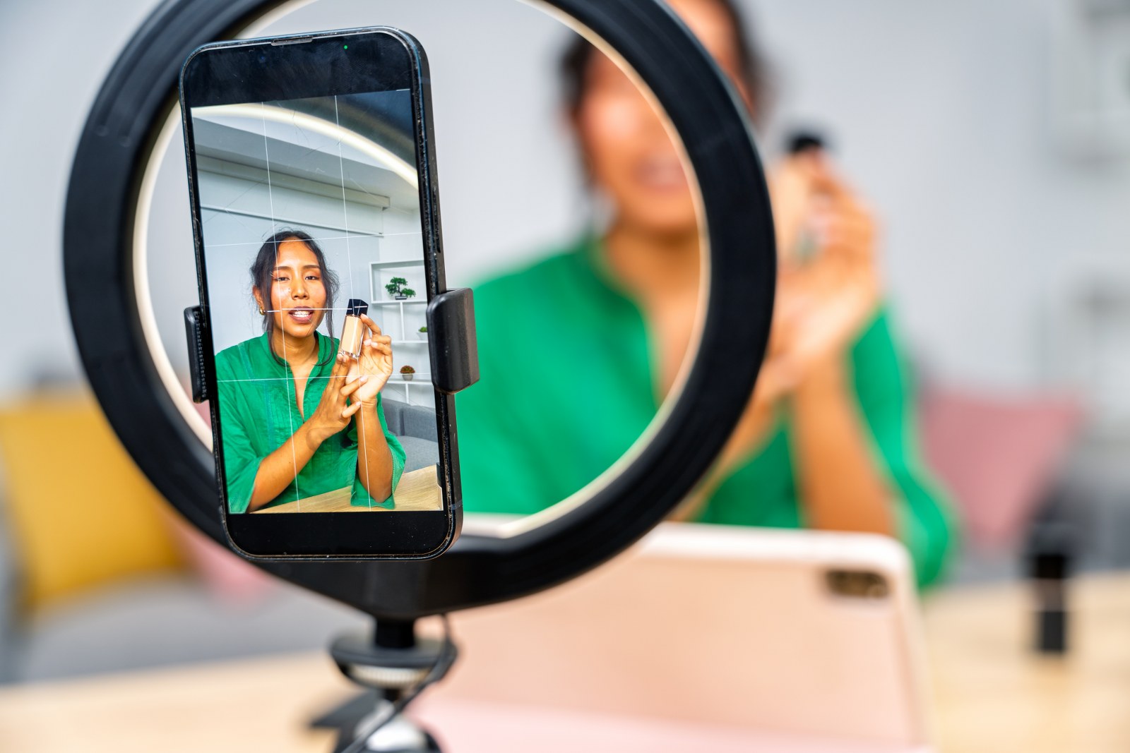 A woman filming a vertical video.