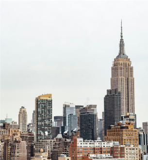 Skyline view of New York City with the Empire State Building in focus.