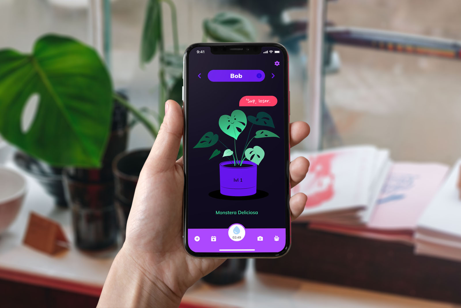 A hand holding an iPhone X with a plant care management app featuring your plant's somewhat rude avatar, along with your real plant in the background.