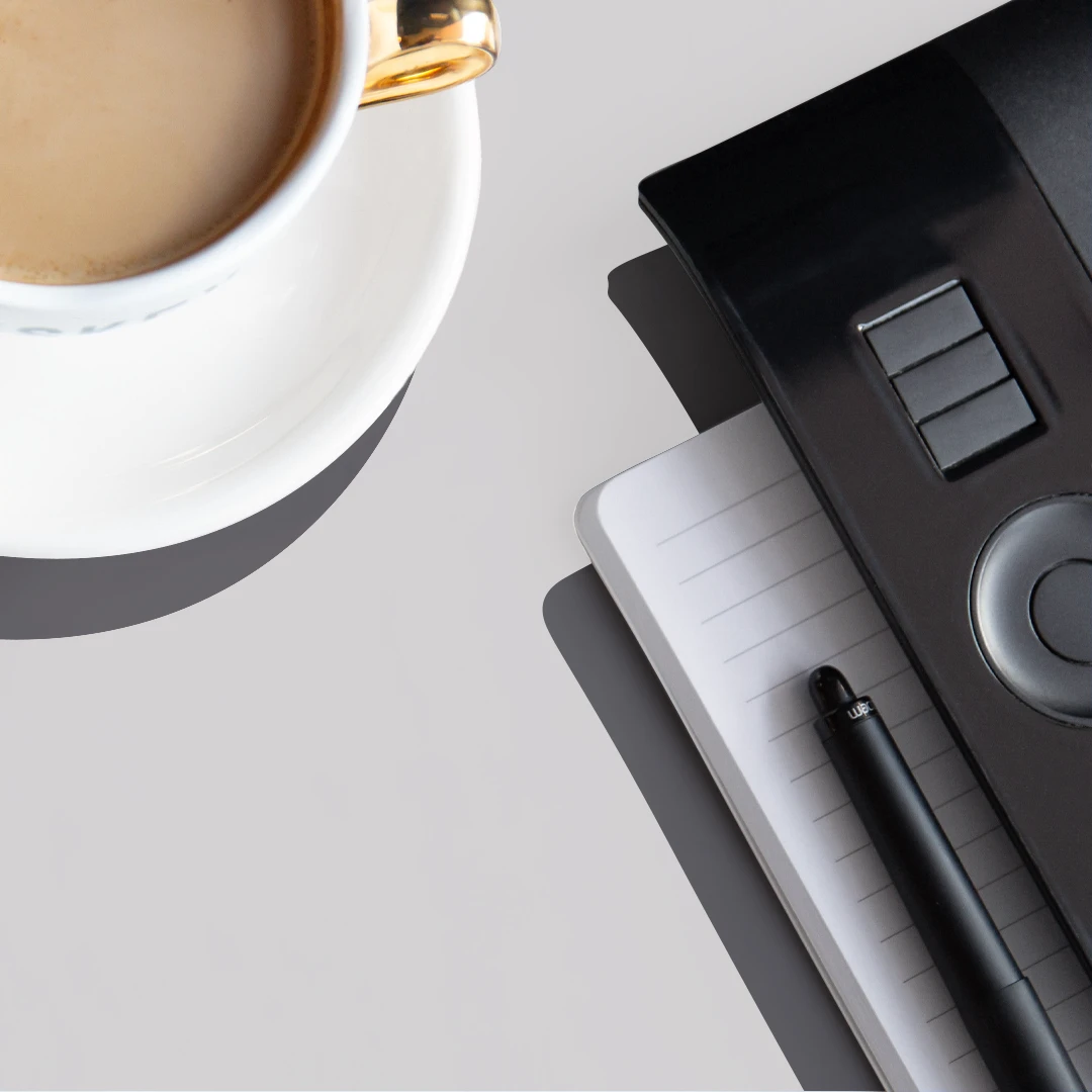 Tablet, pen, notebook and a cappuccino