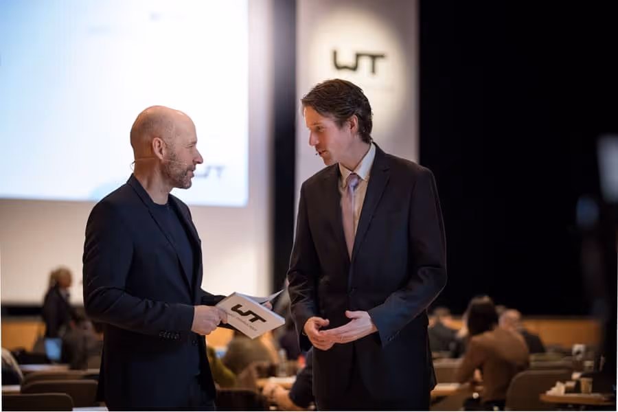 Two men talking at the conference