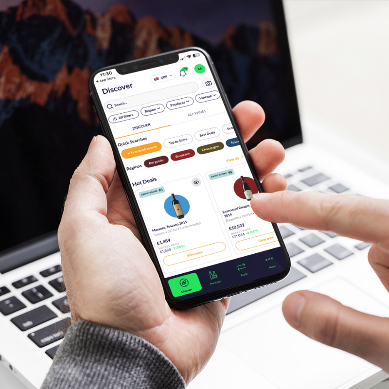 User browsing fine wine offers and market deals on the CultX mobile trading platform with live pricing, scores and wine discovery tools