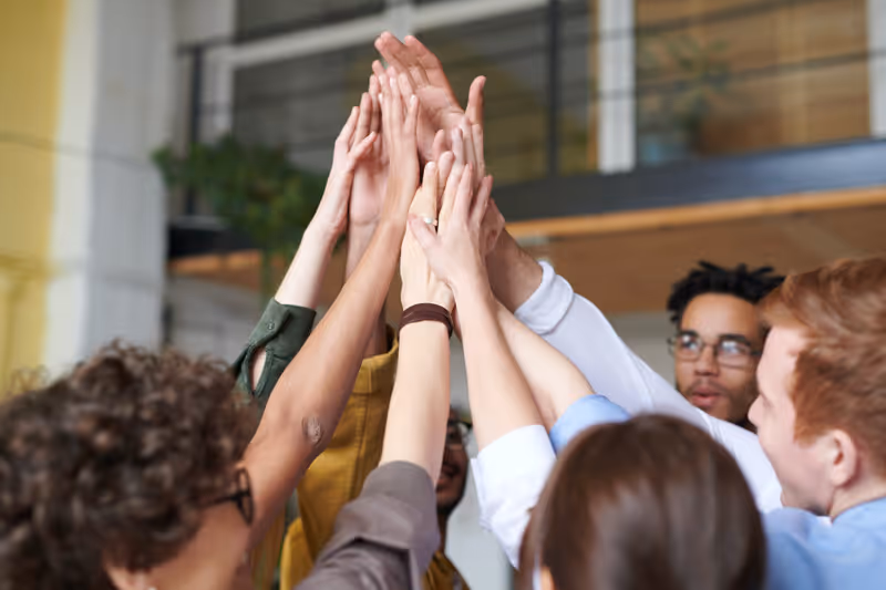 Team celebrating by joining hands