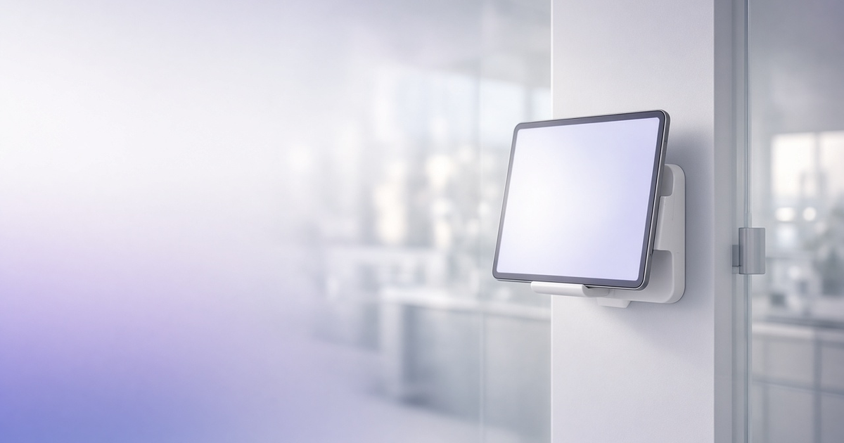 Wall-mounted tablet at a lab entrance, representing LIMS program solutions