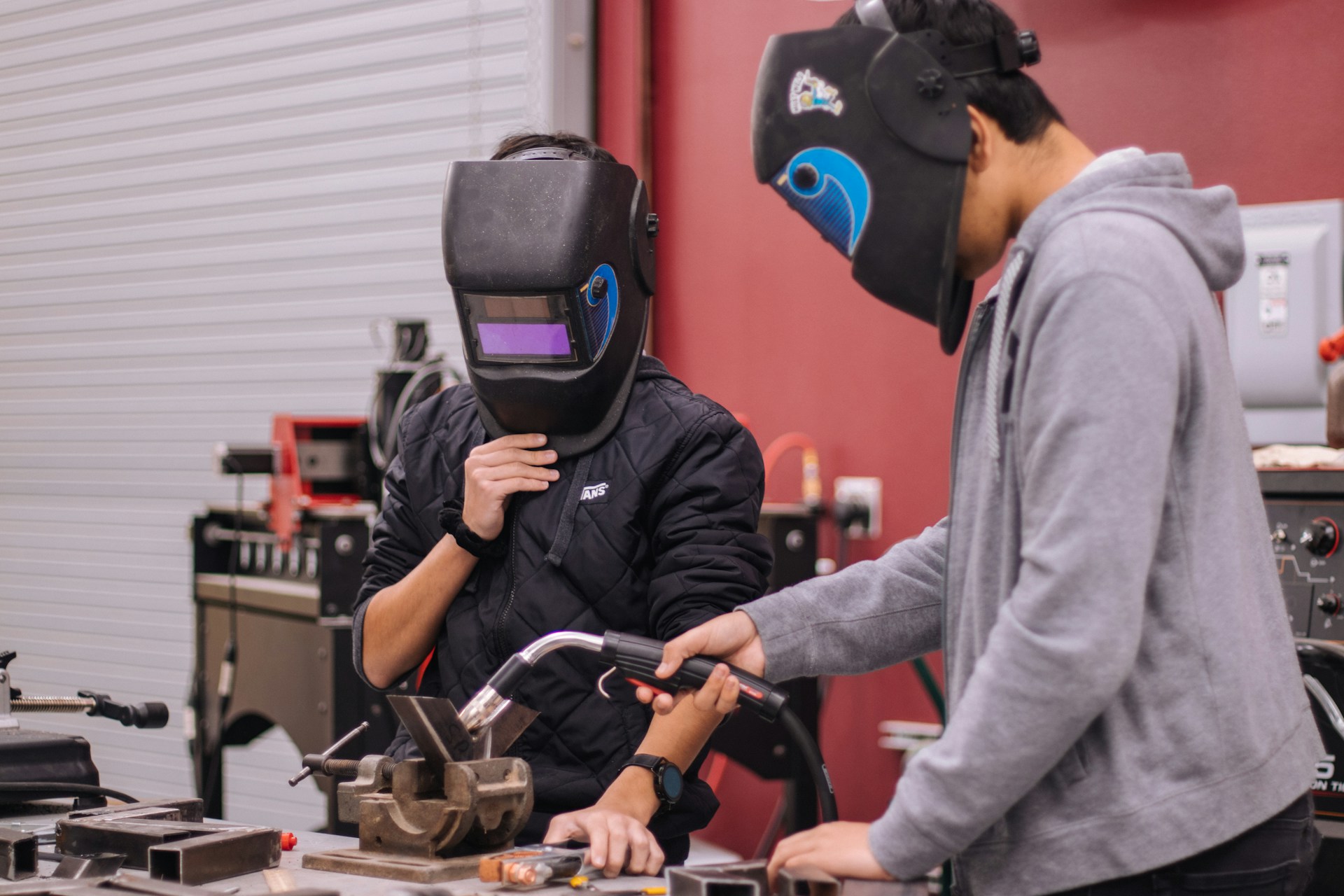 two students in STEM and/or tech class demonstrating welding