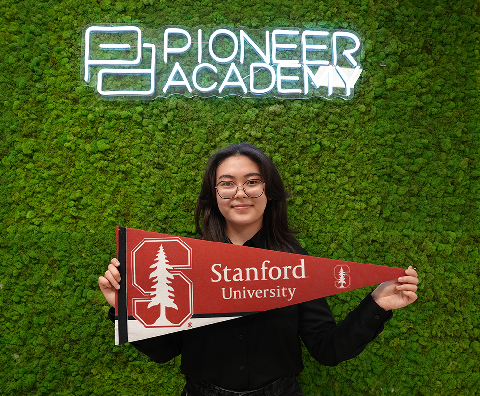 A high school student holding John Hopkins University pennant at Pioneer Academy, Best Private High School