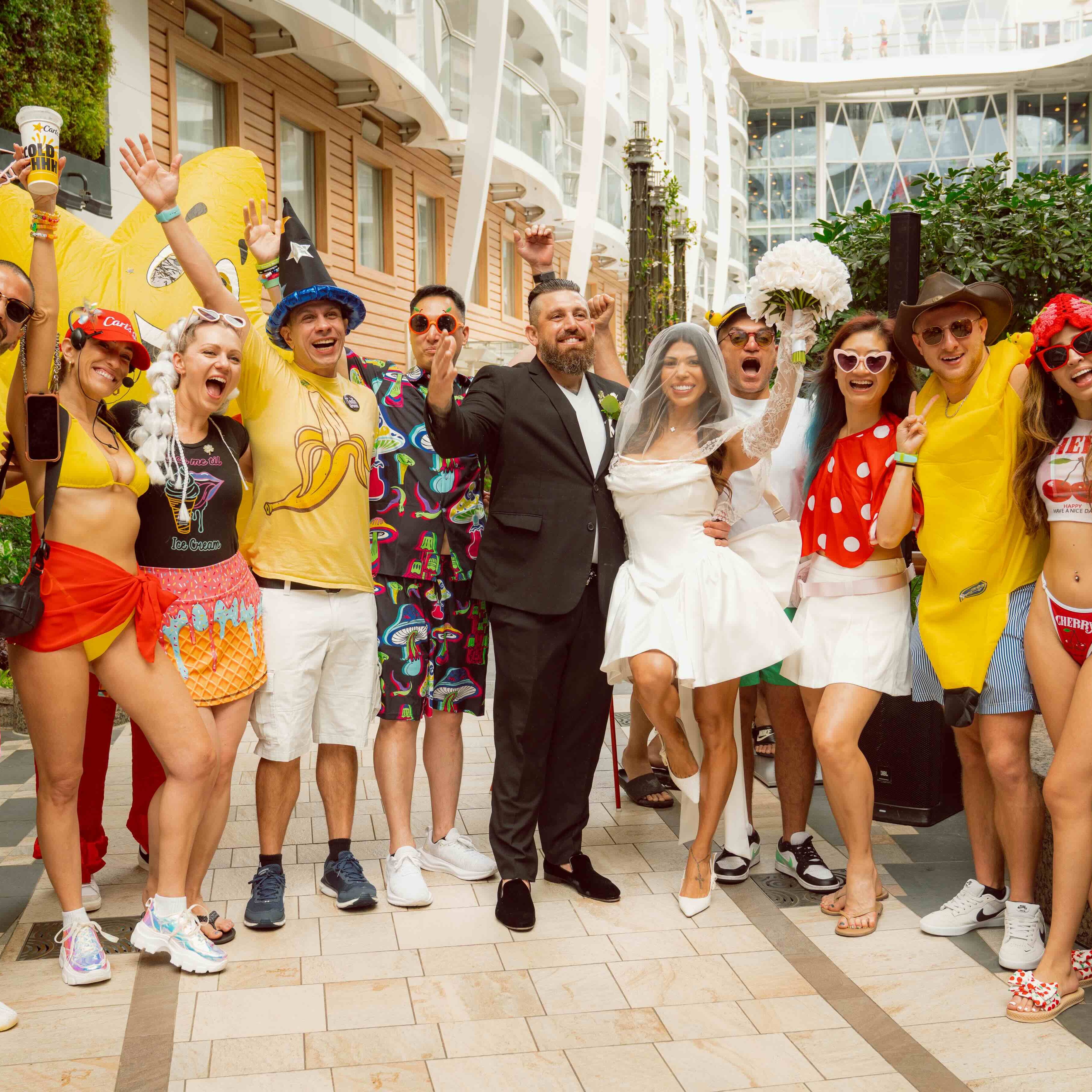 Guests cheer beside an outdoor stage during a Groove Cruise VIP bottle service celebration.