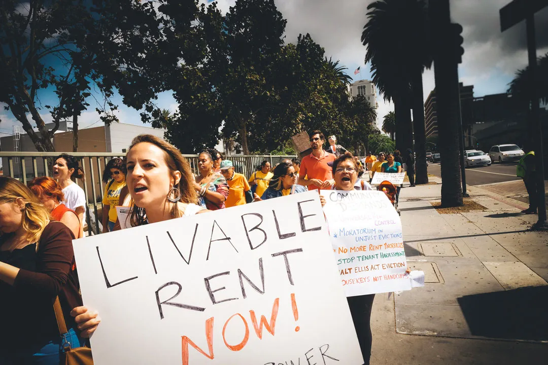 Person hold livable rent poster