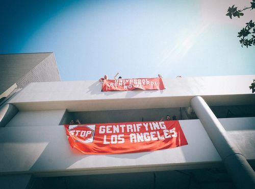 Image of sign that says stop gentrifying los angeles