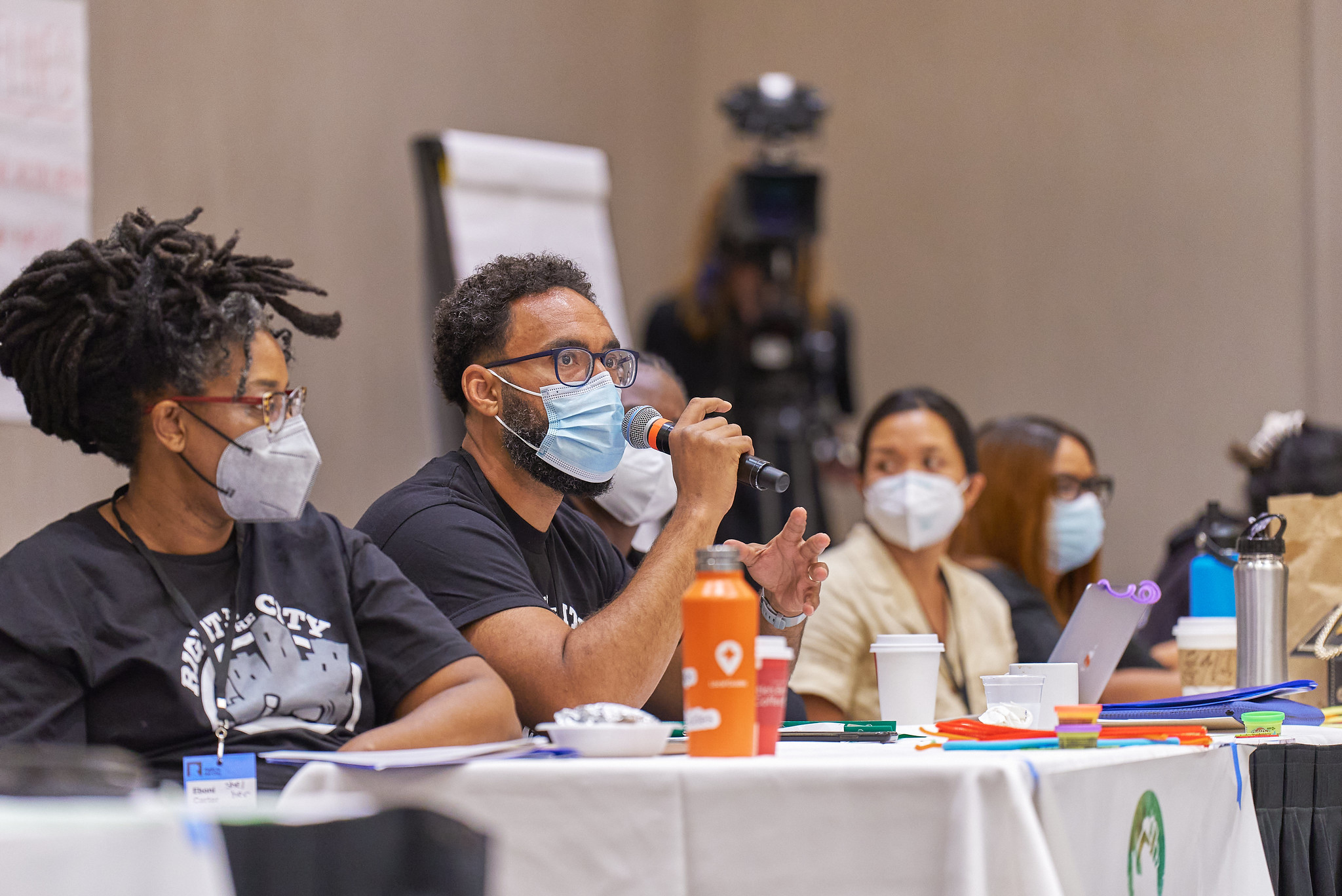 Person speaking on a microphone at RTTC event