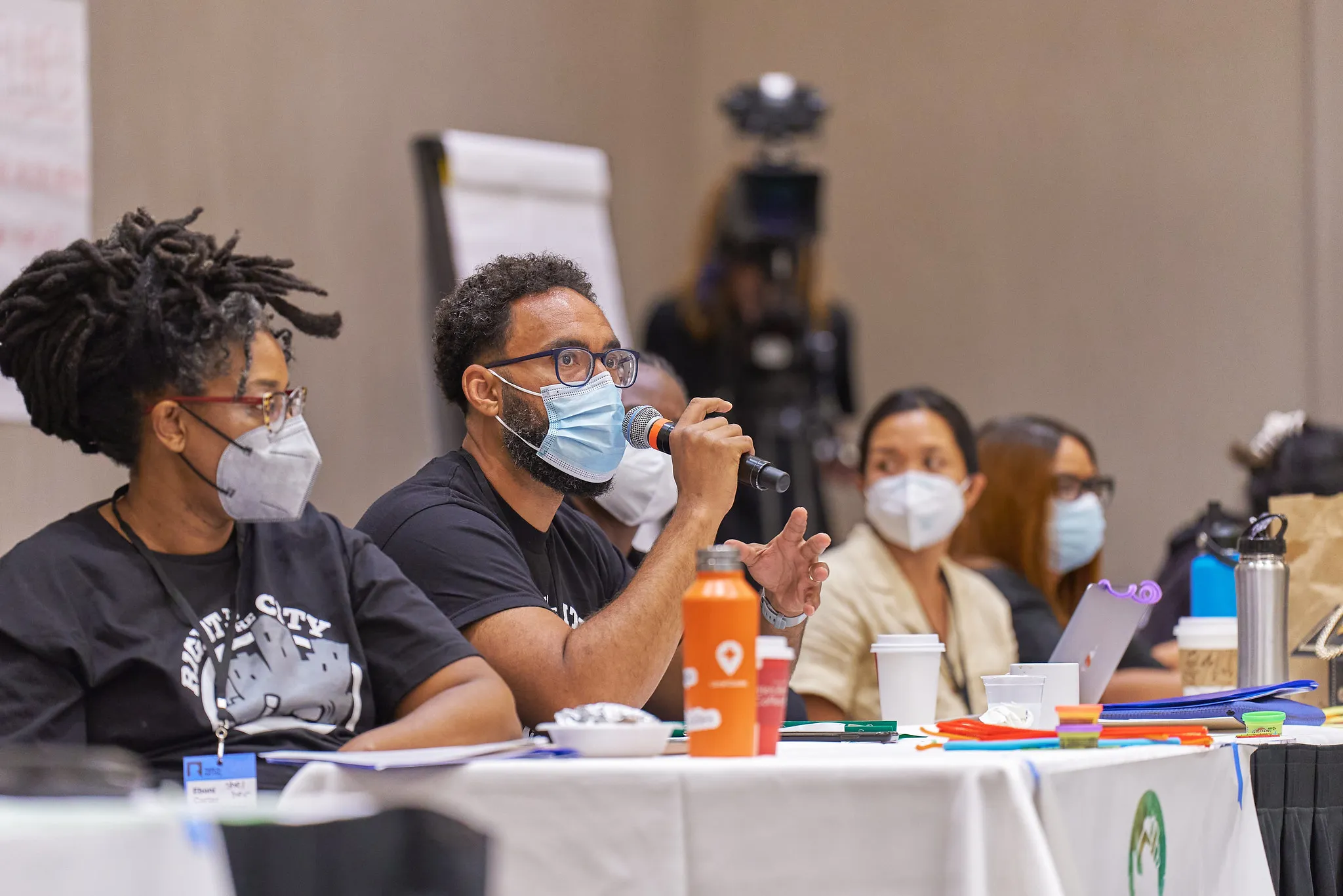 Person speaking on a microphone at RTTC event