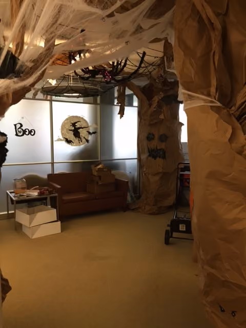 An office decorated like a haunted forest for Halloween.