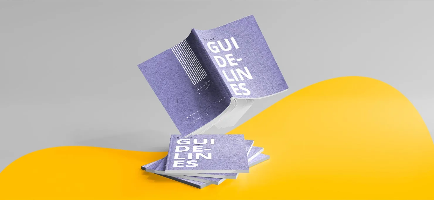 A brand guideline book fluttering above a pile of the same books.