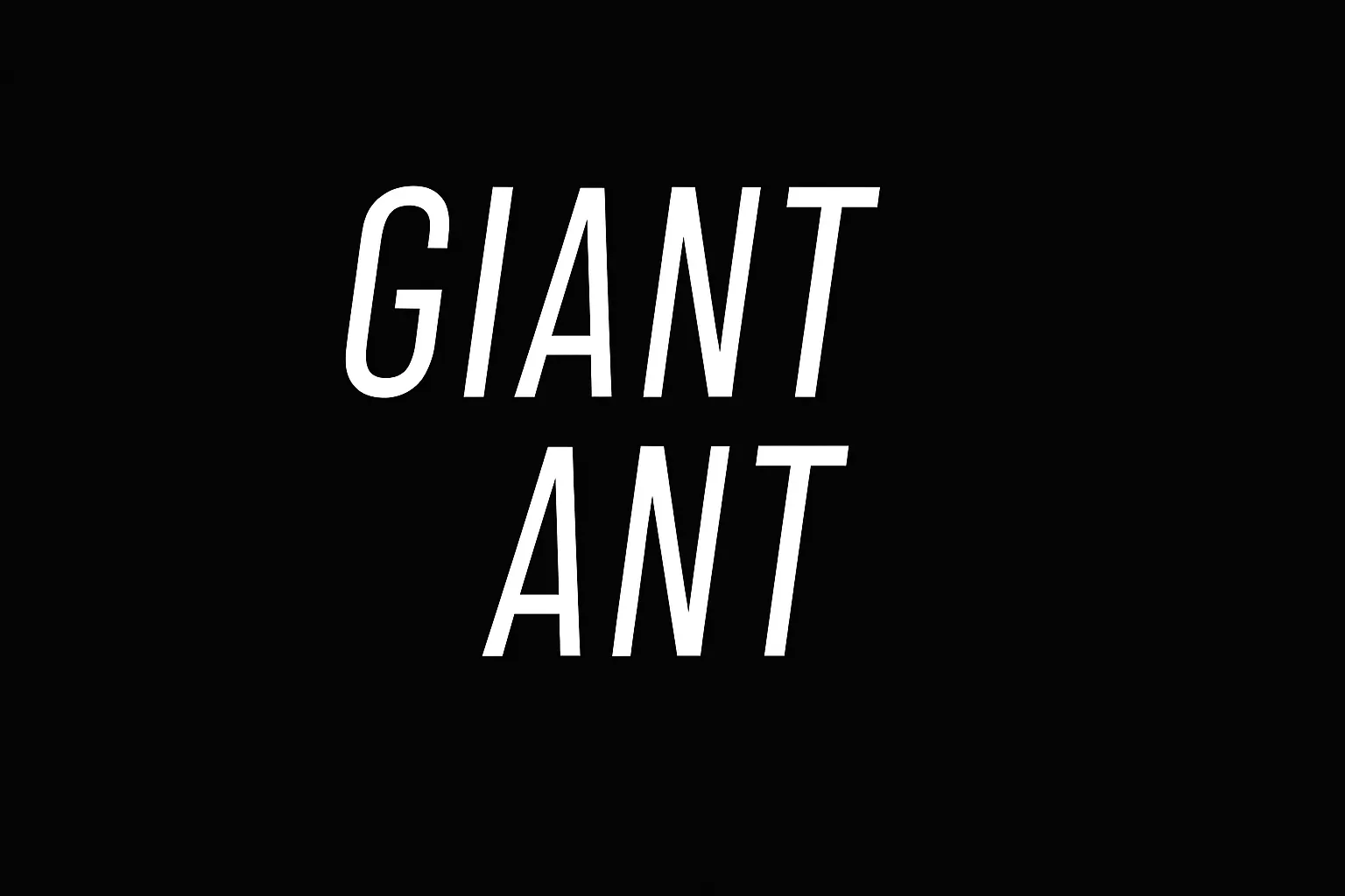 Giant Ant logo with tall white uppercase text stacked vertically on a black background