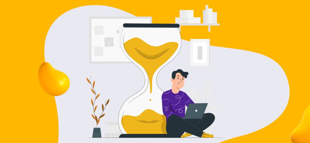 A man working on a computer leaning against an hourglass.