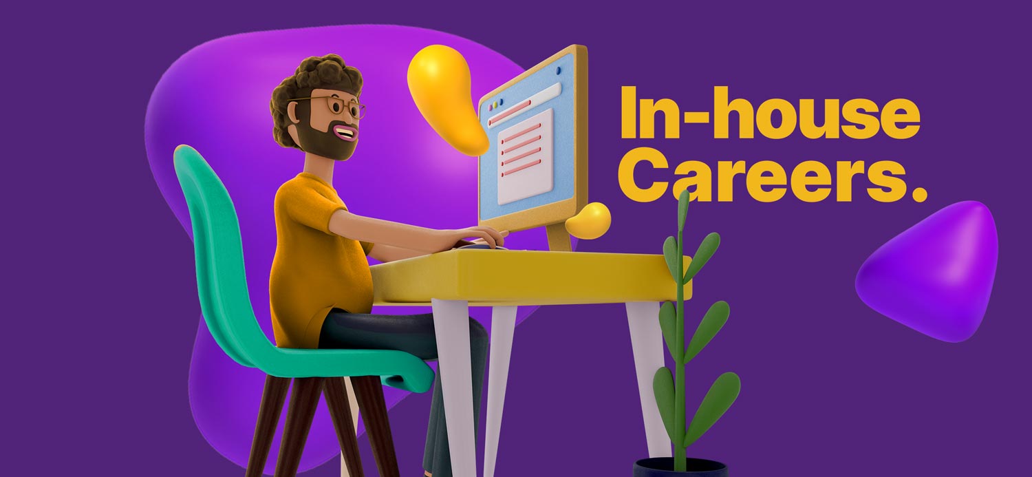 A man working at a computer, doing his in-house job.