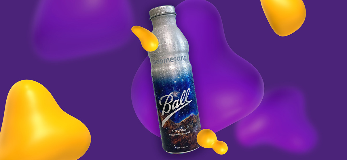 A Boomerang brand metal reusable water bottle. It is decorated with a starry sky over a mountain backdrop.