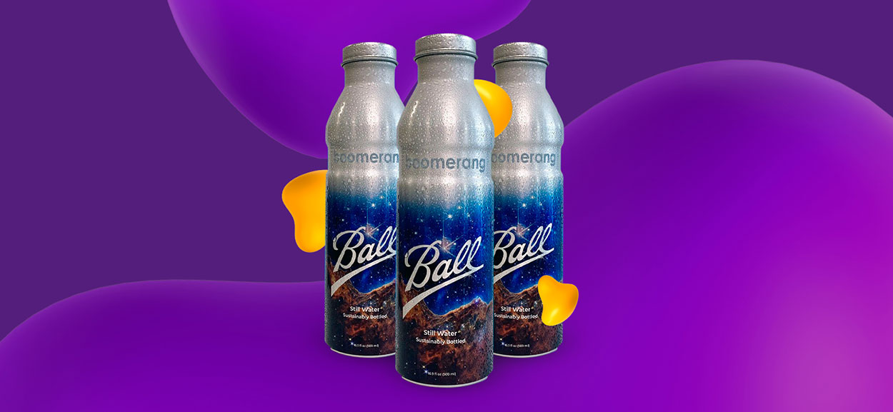 Three Boomerang brand metal water bottles, decorated with night sky imagery.