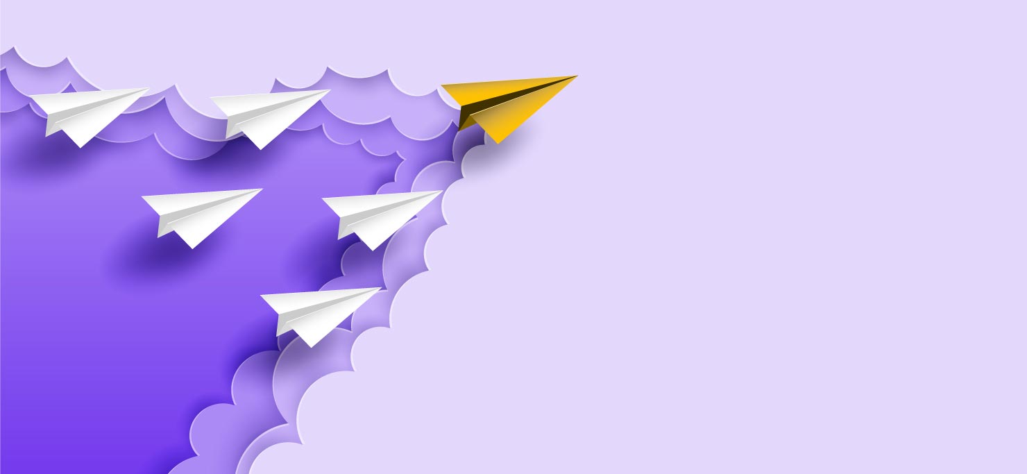 A yellow paper airplane in a V formation with 5 other white paper airplanes.