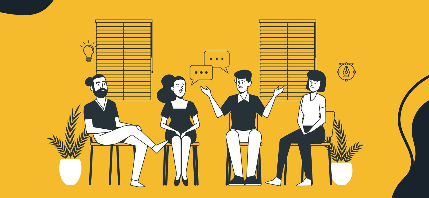 A group of four people sitting around and sharing ideas