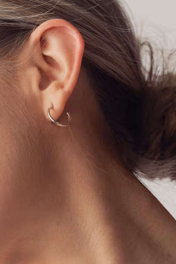 Close-up of a woman’s ear with an earring