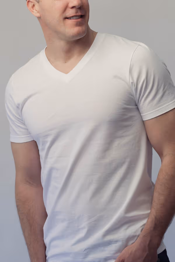 The torso of a man wearing a white t-shirt