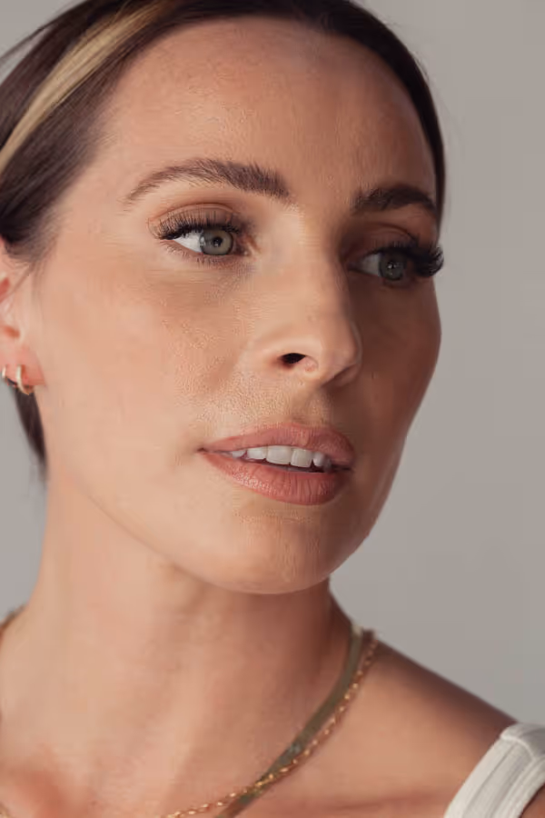 Headshot of a woman with her lips parted