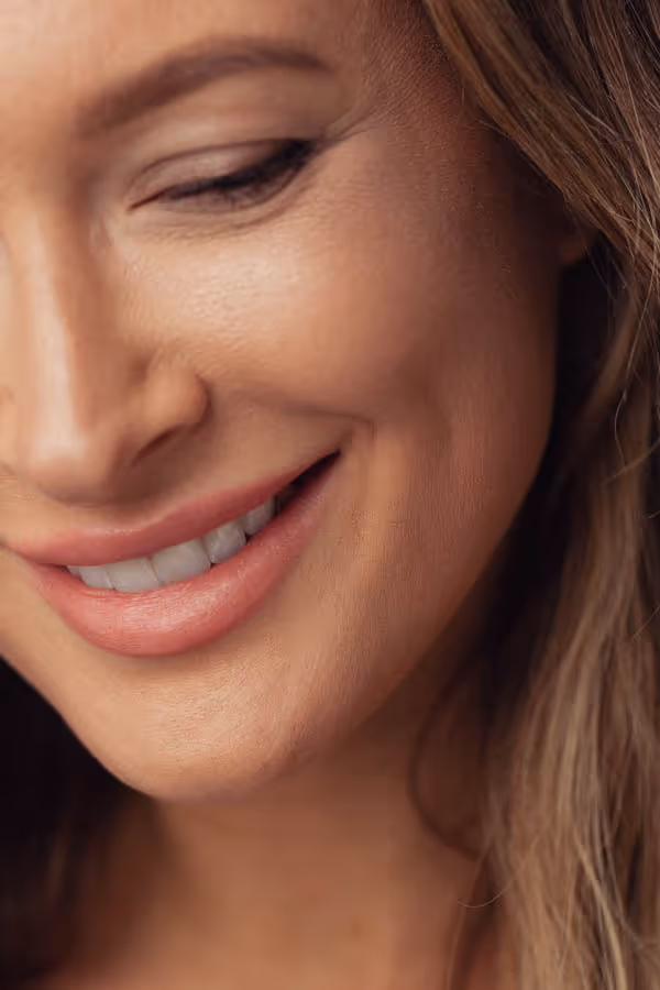 Close-up of half of a woman’s smiling face