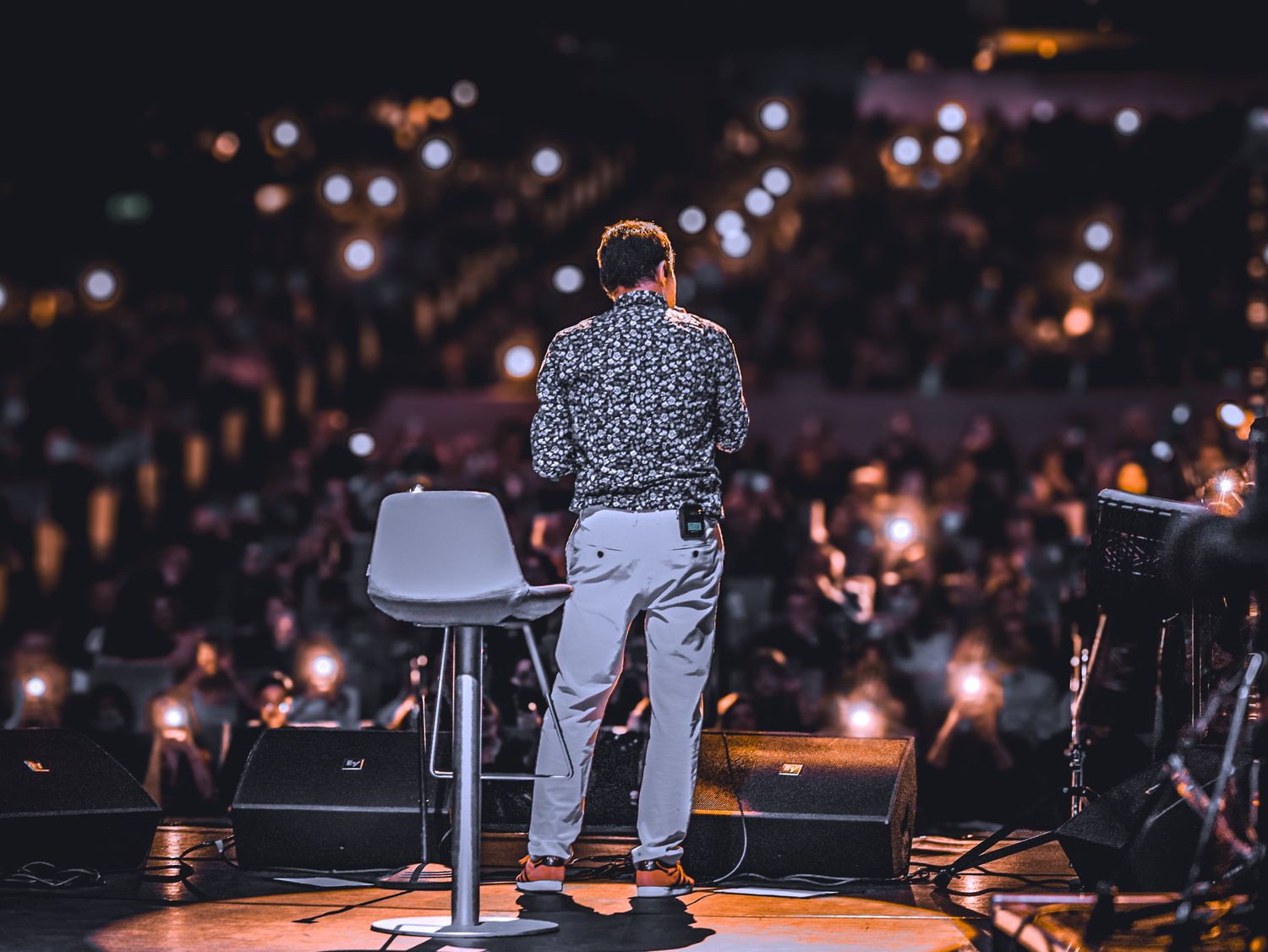 Speaker presenting on stage to an audience
