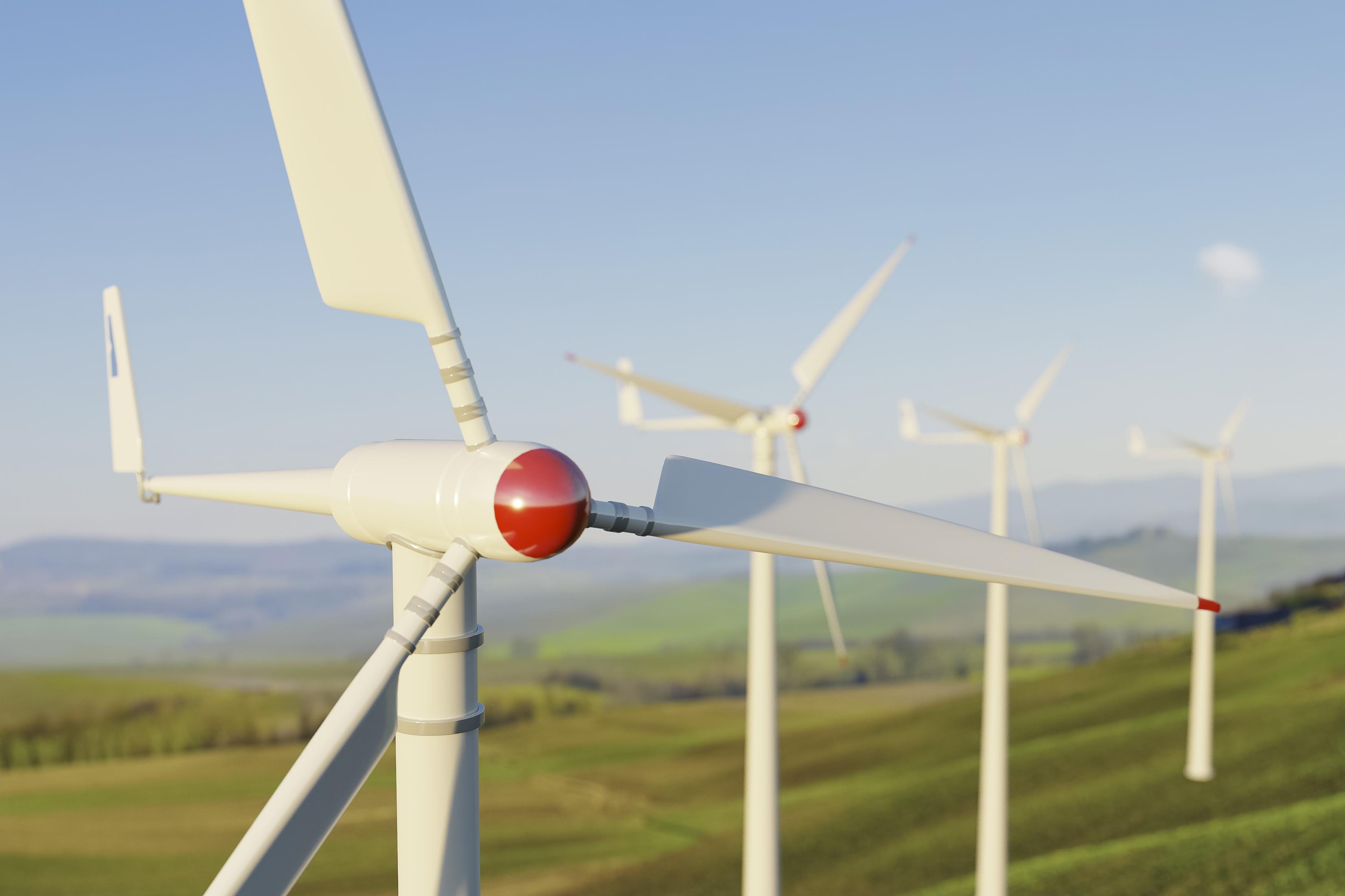 Wind turbines generating renewable energy in a grassy landscape under clear skies