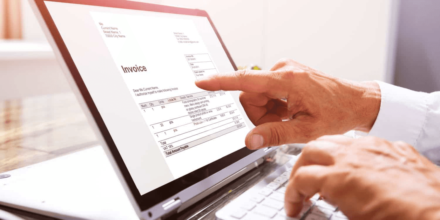  Person reviewing digital invoice on laptop - Contractor Invoice