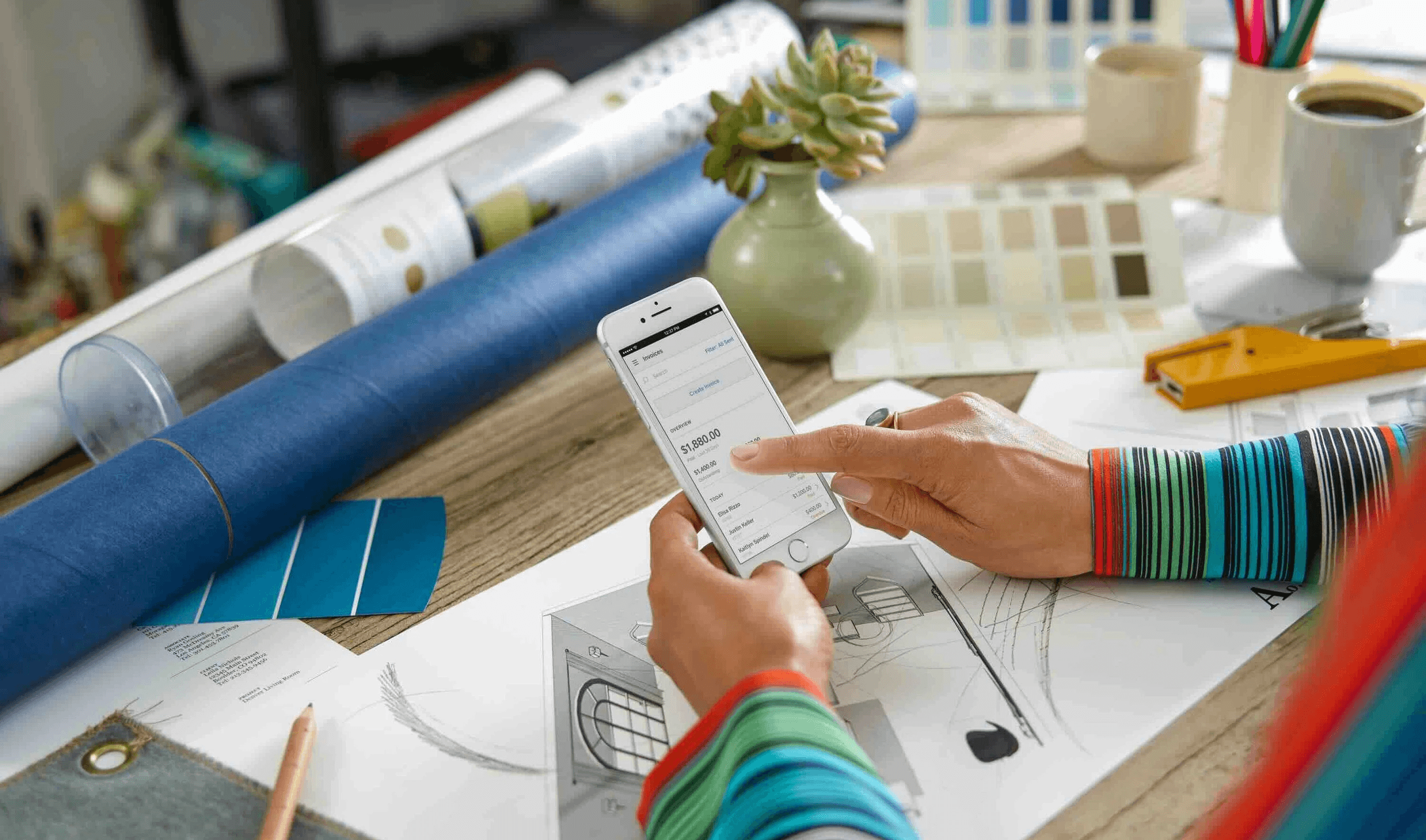 Woman checking digital invoice on smartphone - How to Invoice as a Freelancer