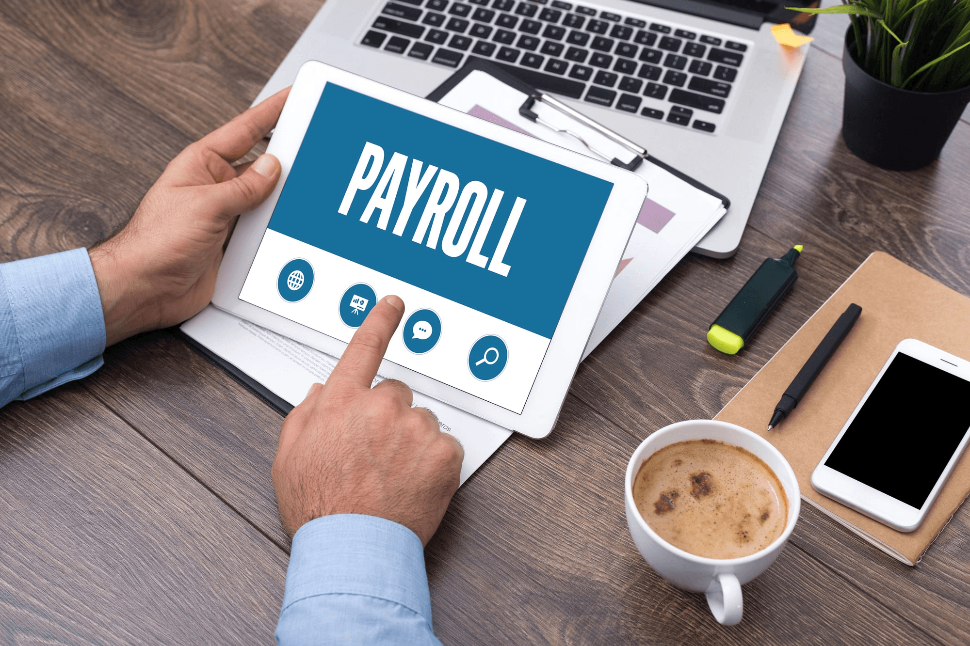 Man using tablet for digital payroll - Global Payroll Trends 