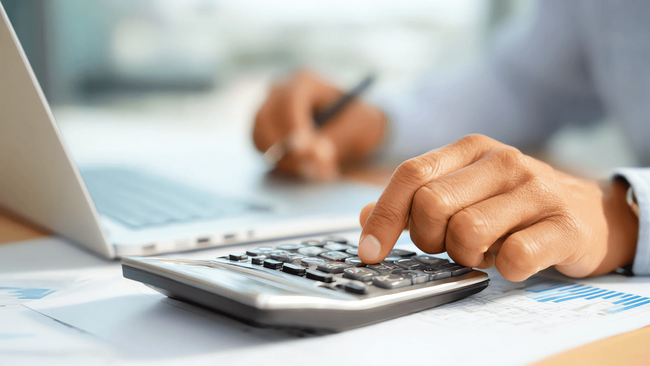 Person calculating data - International Payroll Compliance