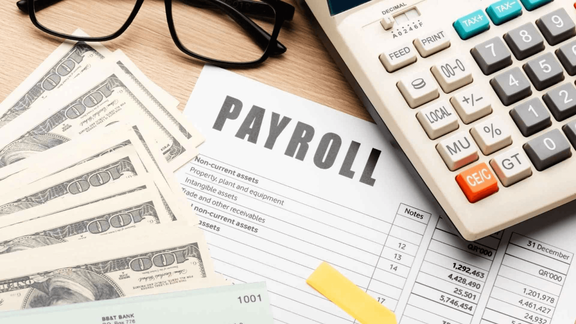Payroll document with cash and calculator - Payroll for Remote Workers