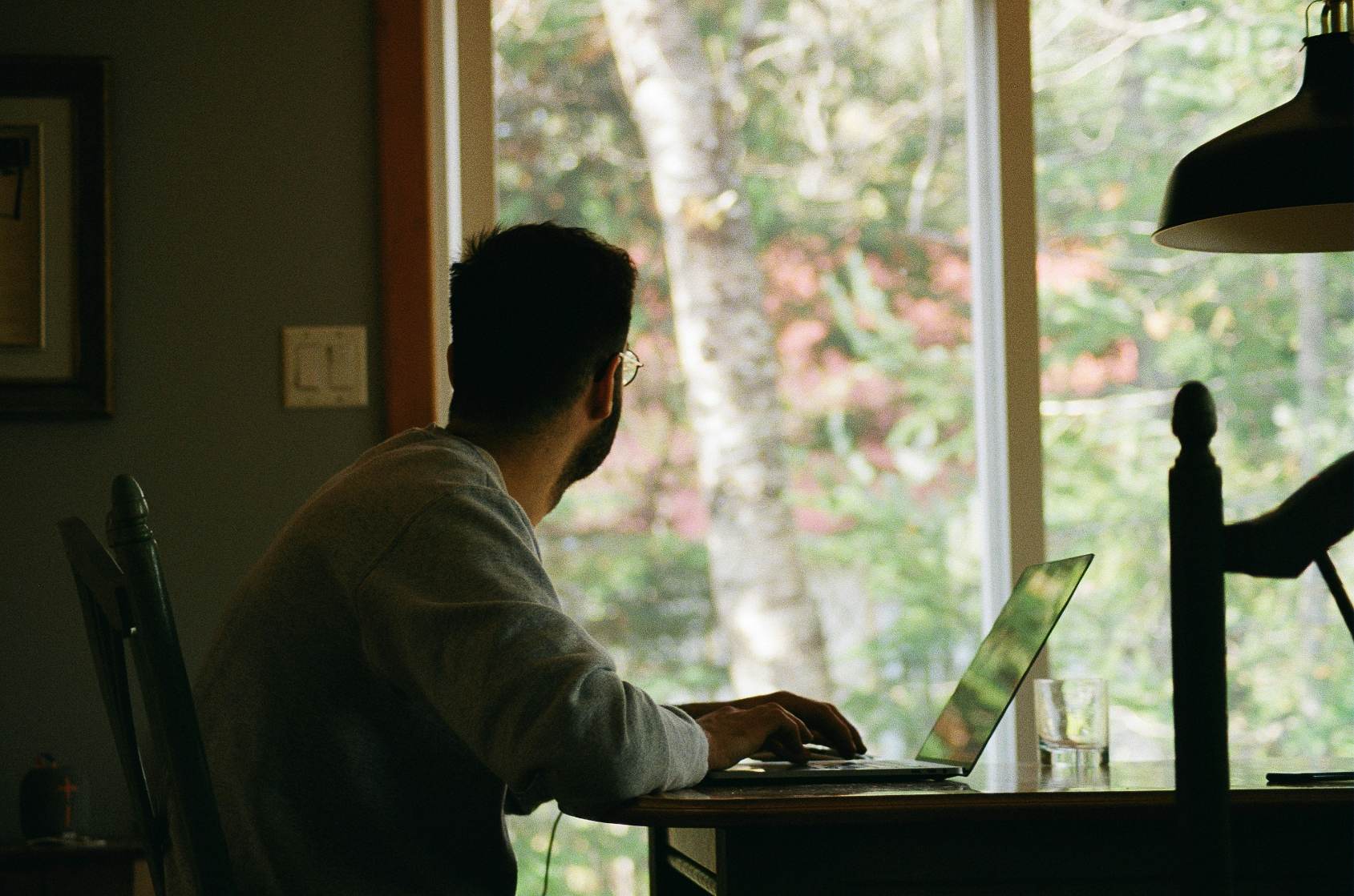 person looking outside the window - International Payroll Management