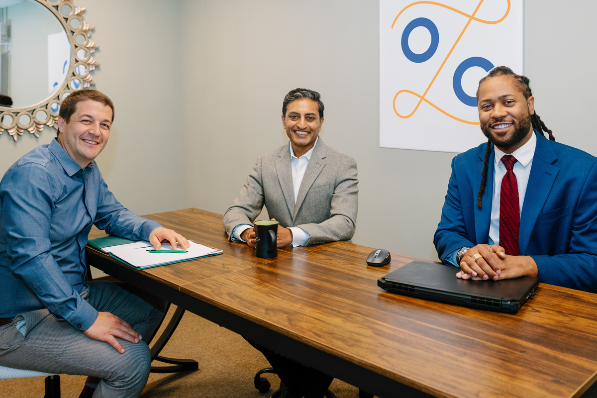Attorneys Kyle, Yogi and Jaleel sitting at table and looking forward to to meeting with you