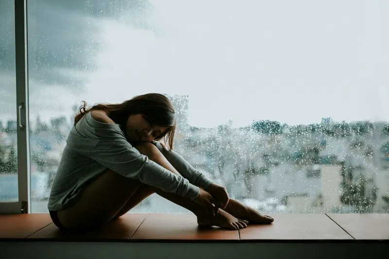 Person feeling emotional changes and discomfort while exploring estradiol vs estrogen differences