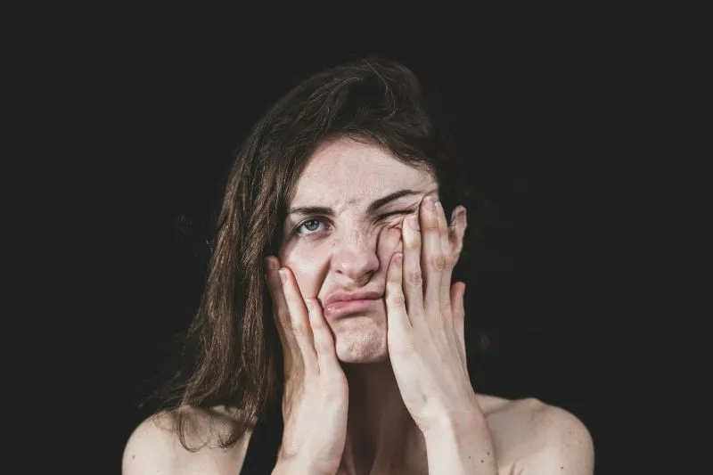 Woman showing signs of hormonal changes for an article about estradiol vs estrogen