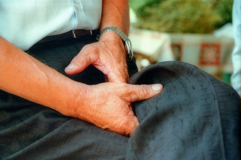 Hands applying pressure to a patient's abdomen during a massage, illustrating the connection behind the question can stress cause diarrhea