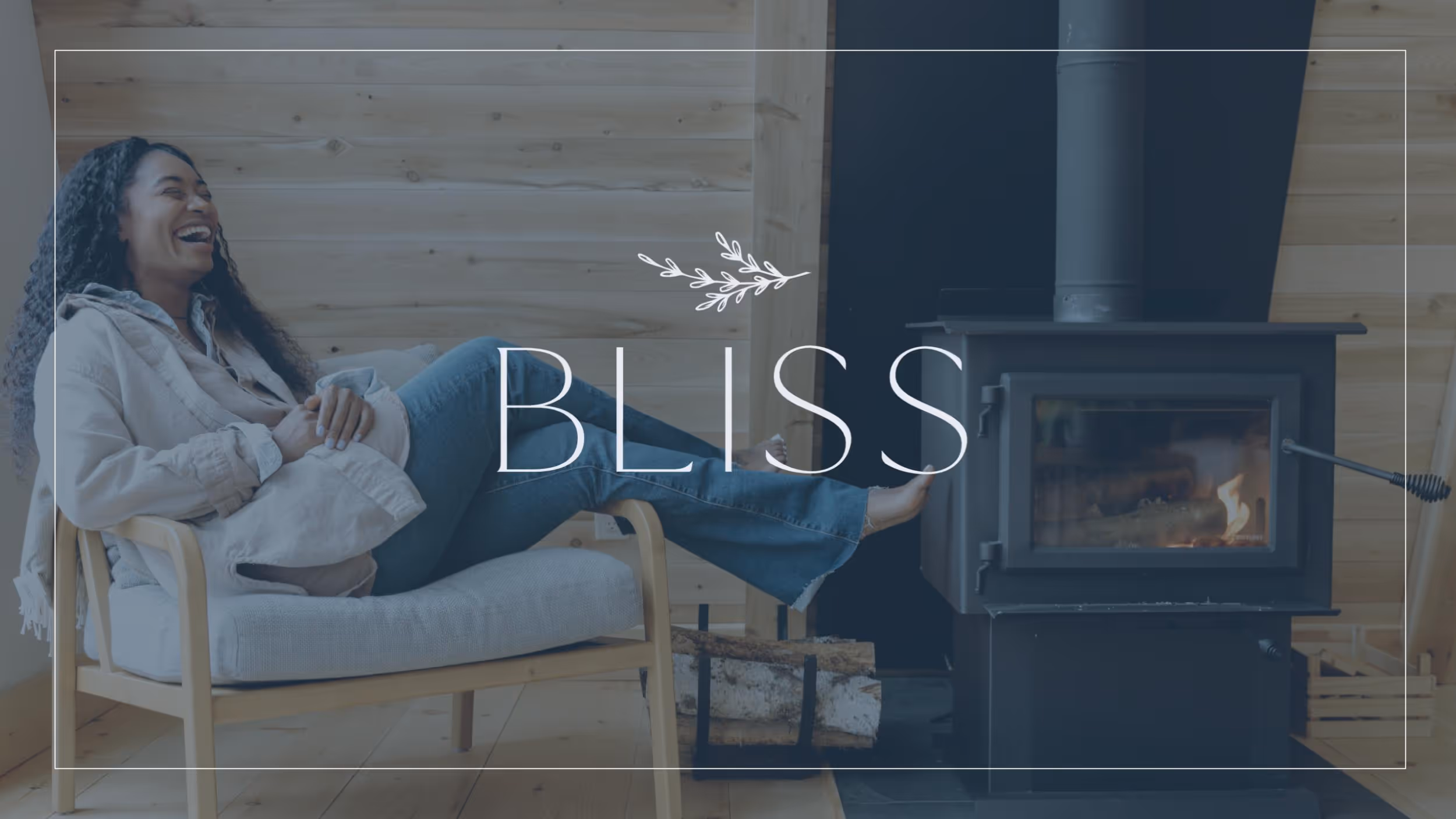 Woman laughing and relaxing in cozy chair near wood stove