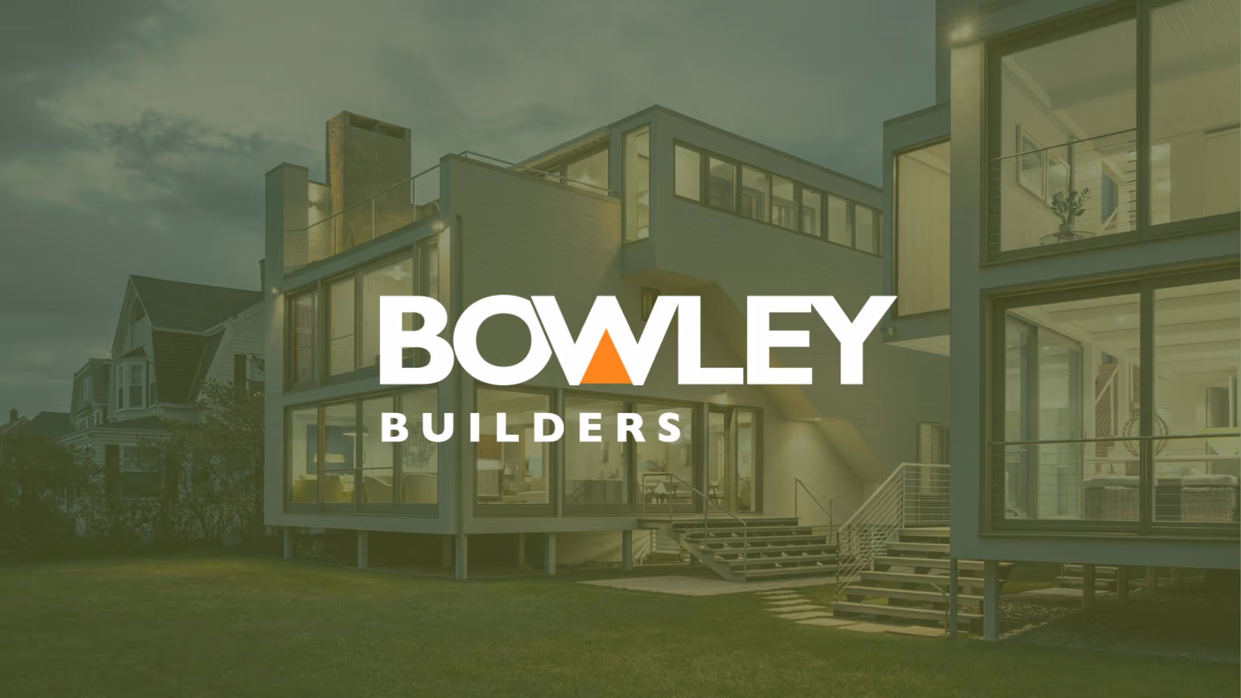 Bowley Builders logo over modern glass house with green lawn