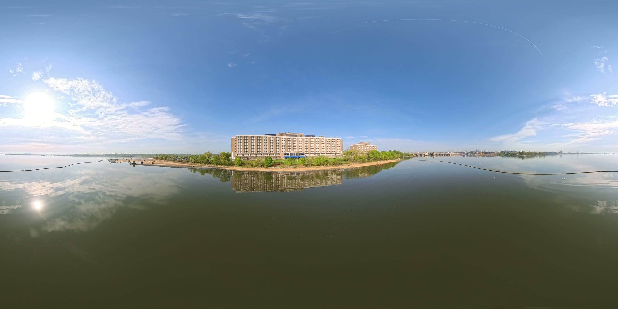 Full 360-degree view of the Parexel building on its waterfront site, with water and a bridge visible on both sides.