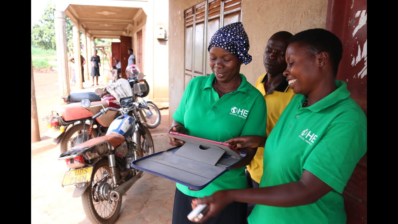 Two women looking at a tablet and smiling