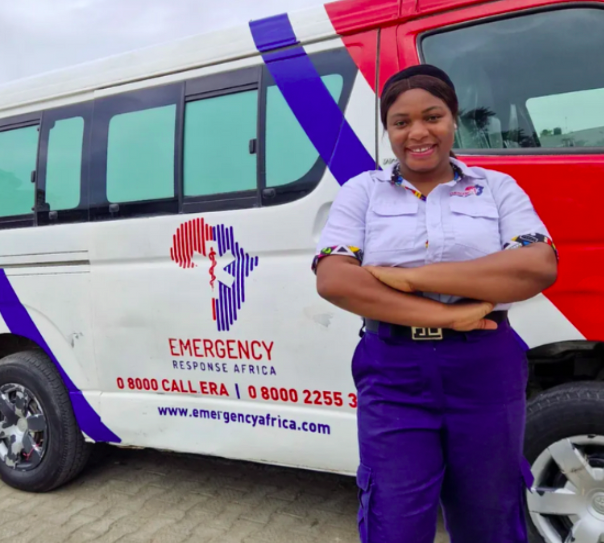 Woman standing in front of an ambulance smiling
