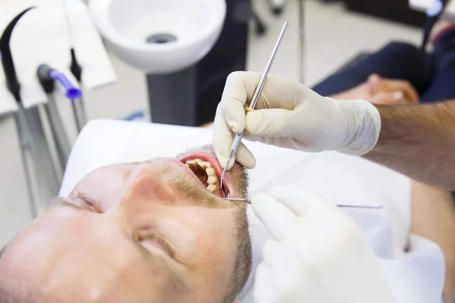 dentist-checking-tmj-treatment-options-with-patient