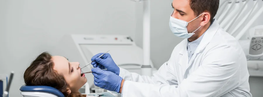 dentist-examining-patient-teeth-family-dentistry-willow-knolls-il