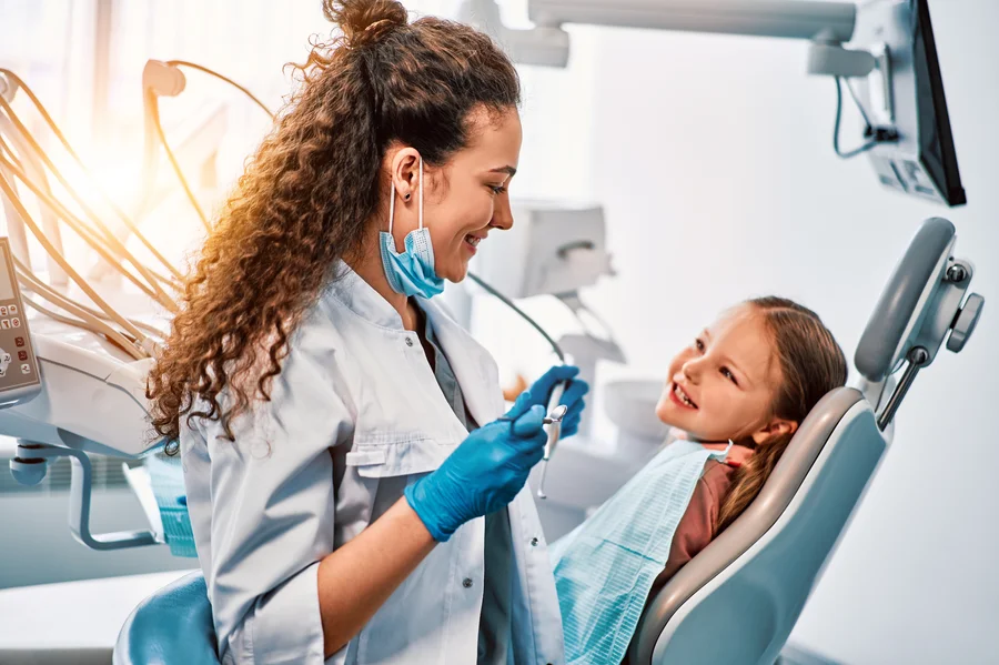 dentist-smiling-with-young-girl-family-dentistry-willow-knolls-il