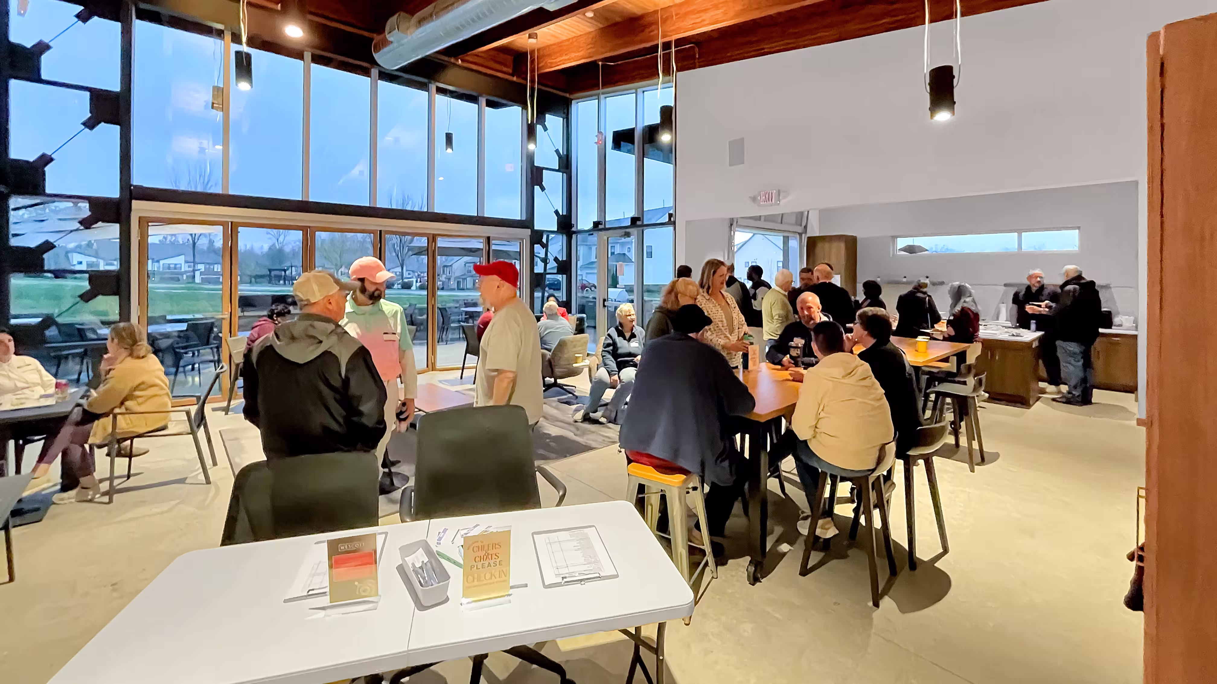 People in a main clubhouse room enjoying conversation at an event